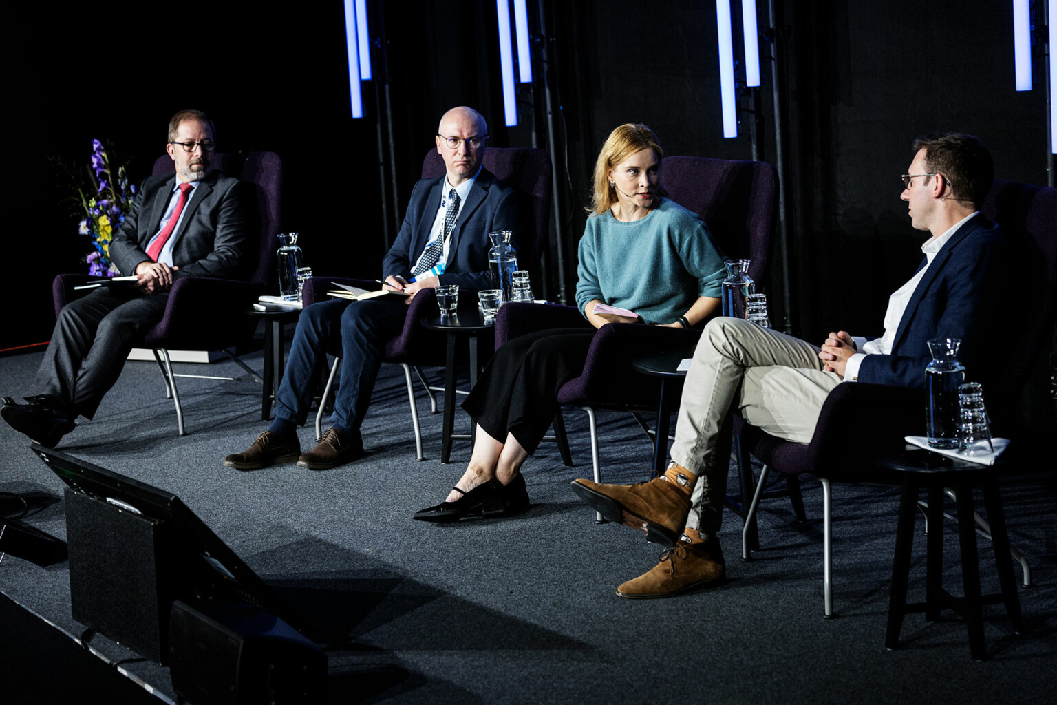 Keir Giles, Stanislav Secrieru, Sinikukka Saari and Henry Foy pictured sitting and talking on stage at the Helsinki Security Forum 2023.