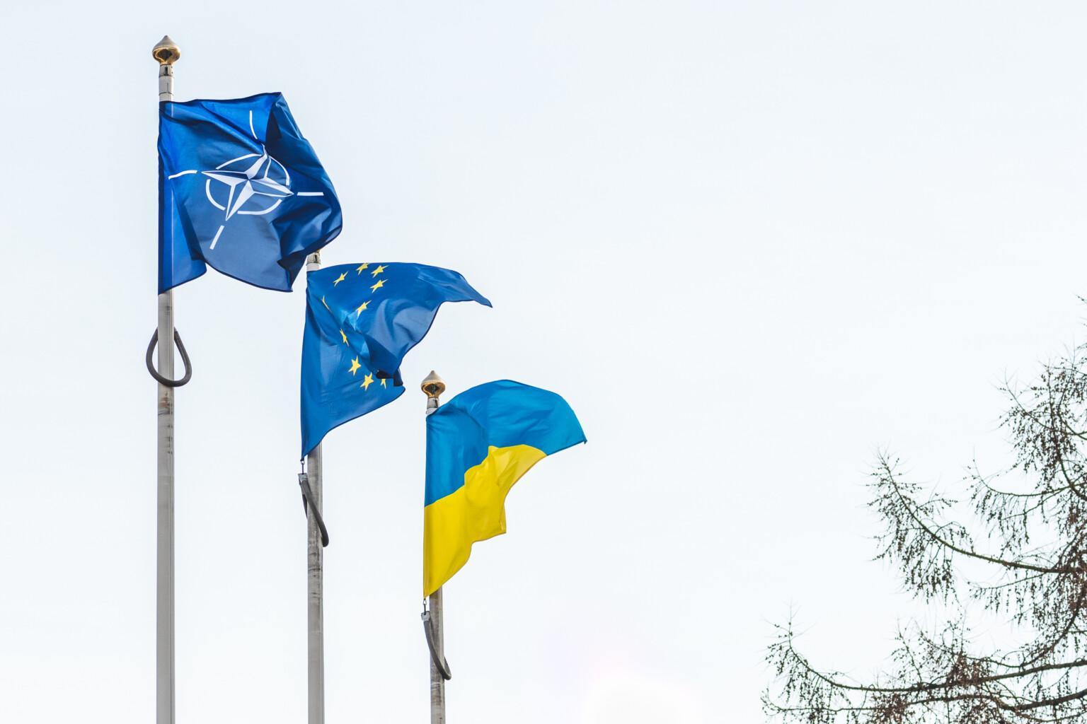 Vilnius, Lithuania - February 16 2022: Flag of NATO, European Union and Ukraine waving together in the sky