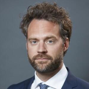 Photo of Mikael Wigell in a suit and tie. 